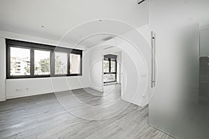 Empty living room in a loft with large black aluminum windows