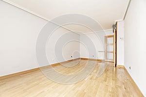 Empty living room with oak parquet and wooden doors