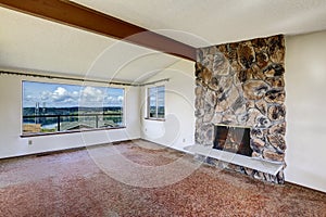 Empty living room with rocky fireplace and beautiful view of Gig