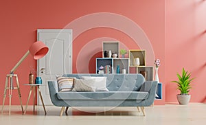 Empty living room with with sofa and green plants,lamp,table,shelves on coral color wall background,3d rendering