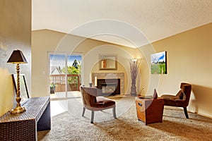 Empty living room in soft ivory with fireplace and walkout deck