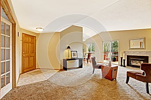 Empty living room in soft ivory with fireplace and walkout deck photo