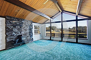 Empty living room with turquoise carpet floor in luxury house.