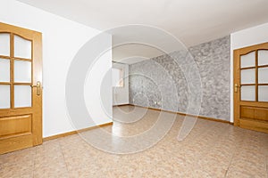 Empty living room with two-tone painted walls, stoneware floors,