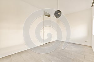 an empty living room with white walls and tile floor