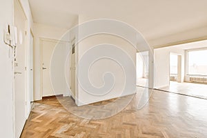 an empty living room with white walls and wood floors