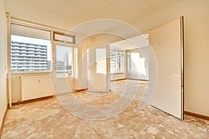 an empty living room with a window and a door