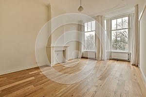 an empty living room with wood floors and windows