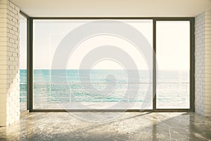 Empty loft room with big window in floor and ocean view