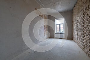 Empty loft room with brick wall and repair and without furniture for office