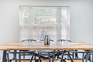 Empty long conference table with black executive office chairs