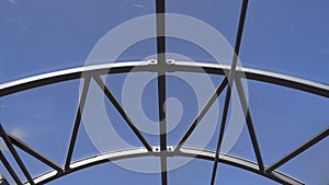 Empty long glass tunnel on the pedestrian bridge,The camera moves through glass tunnel on sunny day with blue sky, at