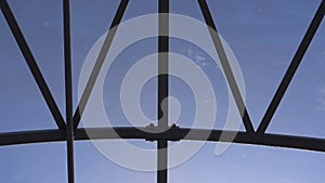 Empty long glass tunnel on the pedestrian bridge,The camera moves through glass tunnel on sunny day with blue sky,