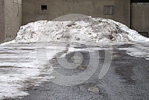 Empty lot with dirty snow pile.