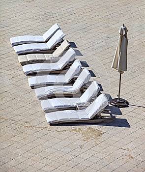 Empty lounge chairs in a row