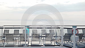 empty lounge chairs on sundecks of the cruise ship while cruising in the international open sea in asia in summer holiday vacation