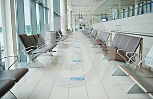 Empty lounge space in airport with chair, waiting room and global travel of covid regulations. Immigration lobby, seat