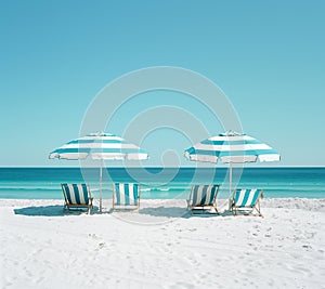 Empty loungers and tents on the white sand beach. Blue sky. Waves in the sea