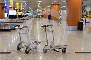 Empty luggage trolleys in the Baggage Reclaim Hall in an airport