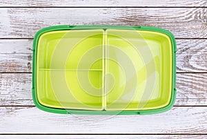 Empty lunch box on wooden table, top view