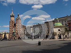 Almost empty Main Square in Krakow during coronavirus covid-19 pandemic.  View over Mariacki Church