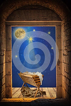 Empty manger under night sky and moon