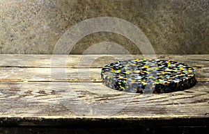 Empty marble log board on wooden table over wall background. Spring and easter mock up for design
