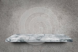 Empty marble shelf over grey concrete wall background