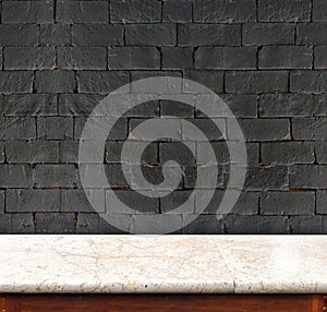 Empty marble table and white black brick wall in background. pro