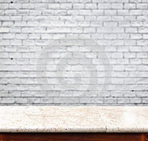 Empty marble table and white brick wall in background. product d