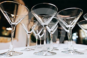 Empty Martini glasses closeup, Wedding reception alcohol drink table