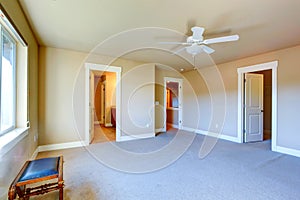 Empty master bedroom with walk-in closet and bathroom