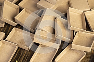 empty matchboxes scattered in a pile , several matchboxes made of paper