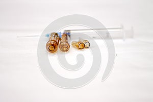 Empty medical ampoules infusion and used syringe after injection  on white background