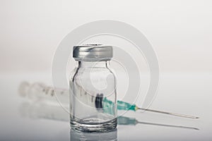 Empty medical vial with syringe and needle