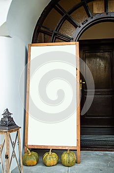 Empty menu board in frame in front of restaurant entrance with w