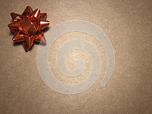 Empty message area with ornament as red bright star, note paper or frame on dark and light brown background.