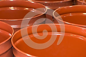 Empty metal barrels for storage and transportation of orange juice in the warehouse of canning orange factory or plant