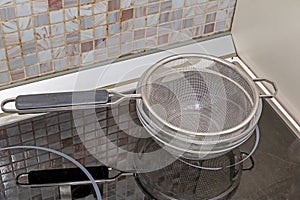 Empty metal strainer in pot