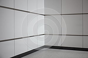 Empty metro station interior with tile wall and floor.