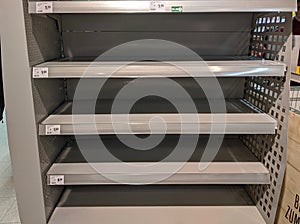 Empty milk shelves in supermarket after panic buying due to outbreaking coronavirus translation:`There is no stock available due t