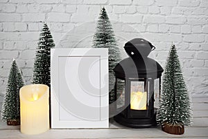 Empty mockup photo frame with LED candlelight on white brick wall background