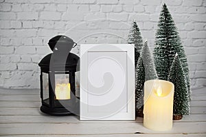 Empty mockup photo frame with LED candlelight on white brick wall background