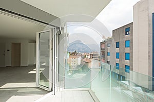 Empty modern apartment, balcony. Cloudy day