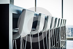 Empty modern chairs in a row in an office building