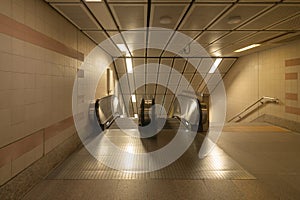 Empty modern escalator at subway station. Electric system moving staircase. Floor and step level. Transportation in underground