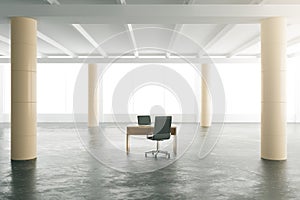 Empty modern hangar with concrete floor and table with chairs