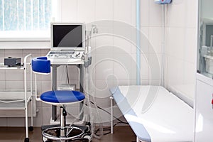 Empty modern interior of clinic hospital office with ultrasound scanner equipment. Diagnostics, sonography and health