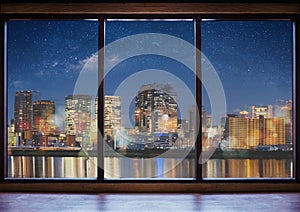 Empty modern interior space with city view at night and starry sky