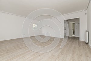 Empty modern living room with white painted walls, double access door, small window on a wall with wooden floors and light parquet